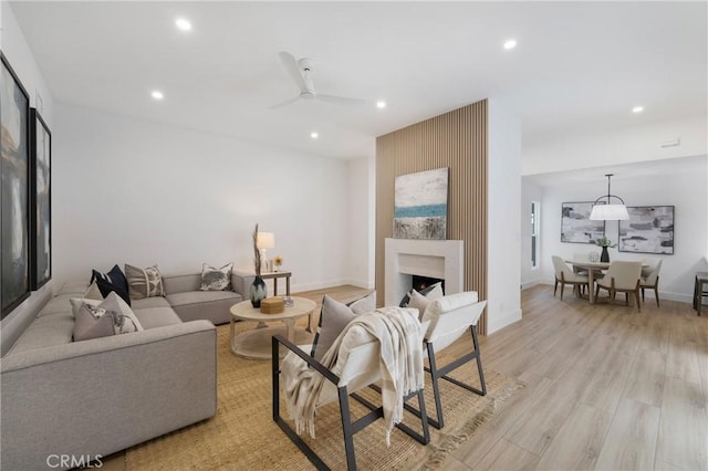44 Seton Rd, Irvine, CA 92612 - living room with recessed lighting, light wood-type flooring, ceiling fan, and a fireplace