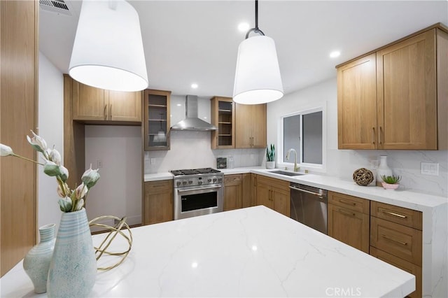 44 Seton Rd, Irvine, CA 92612 - kitchen with stainless steel appliances, wall chimney exhaust hood, decorative backsplash, brown cabinetry, and recessed lighting