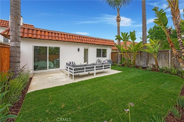 44 Seton Rd, Irvine, CA 92612 - back of property with a fenced backyard, a tile roof, an outdoor living space, stucco siding, and a patio