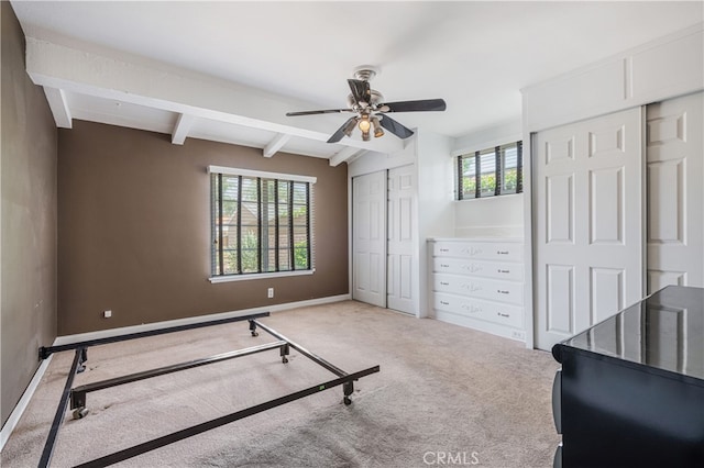 10430 Balboa Blvd, Granada Hills, CA 91344 - unfurnished bedroom featuring multiple closets, beamed ceiling, carpet, and a ceiling fan