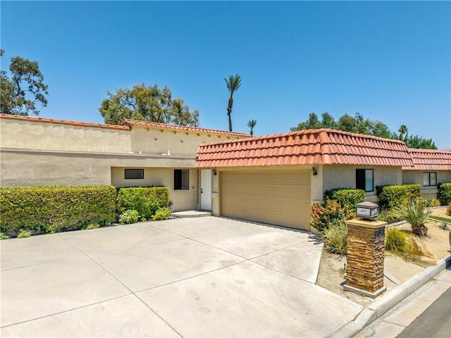 40316 Bay Hill Way, Palm Desert, CA 92211 - mediterranean / spanish home with an attached garage, concrete driveway, stucco siding, and a tiled roof