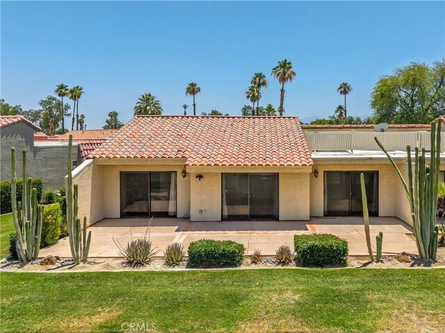 40316 Bay Hill Way, Palm Desert, CA 92211 - back of property with stucco siding, a patio area, a yard, and a tiled roof