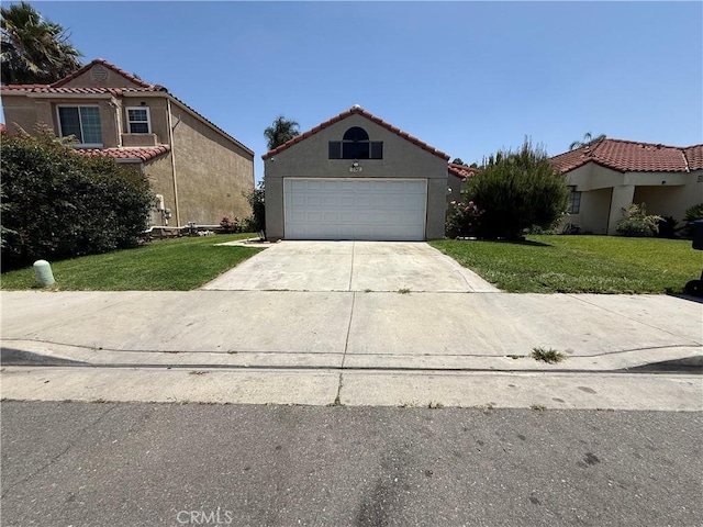3567 Ganador Ct, Riverside, CA 92503 - view of front of house featuring a front yard, concrete driveway, stucco siding, and a tile roof