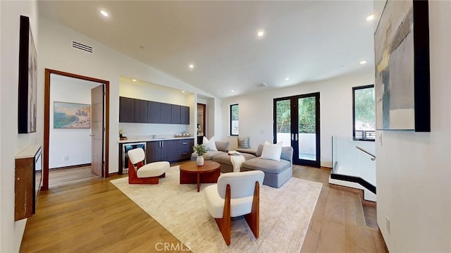 12480 Viewcrest Rd, Studio City, CA 91604 - living area featuring light wood-type flooring, recessed lighting, vaulted ceiling, beverage cooler, and french doors