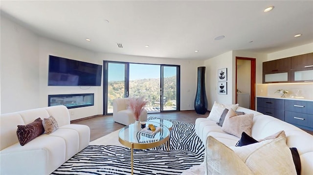 12480 Viewcrest Rd, Studio City, CA 91604 - living area featuring wood finished floors, recessed lighting, and a glass covered fireplace