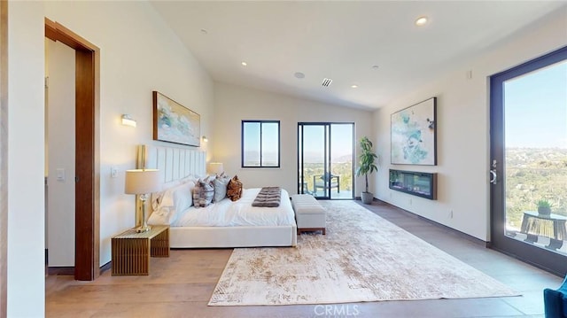 12480 Viewcrest Rd, Studio City, CA 91604 - bedroom with access to outside, vaulted ceiling, a glass covered fireplace, recessed lighting, and wood finished floors