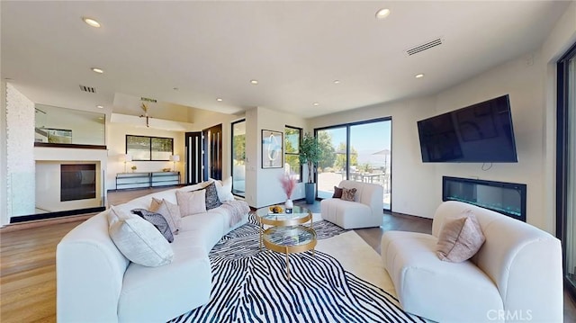 12480 Viewcrest Rd, Studio City, CA 91604 - living room with a glass covered fireplace, wood finished floors, and recessed lighting