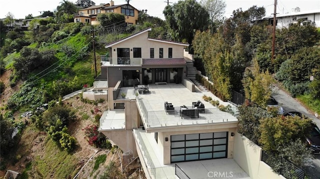 12480 Viewcrest Rd, Studio City, CA 91604 - rear view of house with stairway, stucco siding, a garage, outdoor dining area, and a patio
