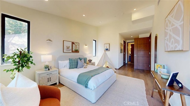 12480 Viewcrest Rd, Studio City, CA 91604 - bedroom with wood finished floors, recessed lighting, and arched walkways