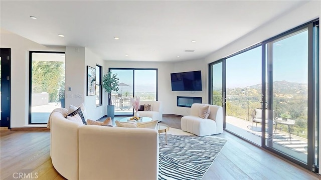 12480 Viewcrest Rd, Studio City, CA 91604 - living room featuring light wood finished floors, healthy amount of natural light, and recessed lighting