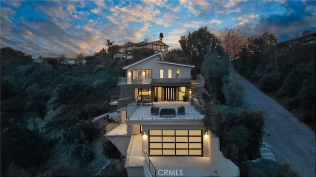 12480 Viewcrest Rd, Studio City, CA 91604 - back of property featuring a balcony, a garage, and stucco siding