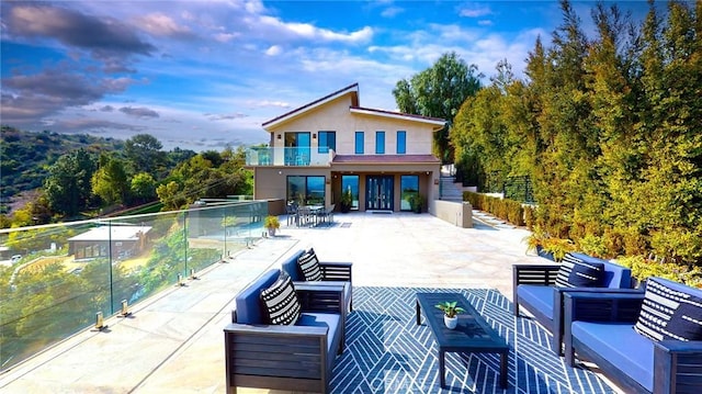 12480 Viewcrest Rd, Studio City, CA 91604 - rear view of property featuring a balcony, an outdoor hangout area, stucco siding, and a patio