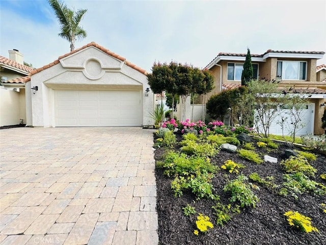 83 Palm Beach Ct, Dana Point, CA 92629 - view of front facade with stucco siding, an attached garage, a tile roof, and decorative driveway
