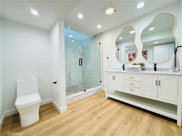 83 Palm Beach Ct, Dana Point, CA 92629 - bathroom featuring double vanity, a marble finish shower, wood finished floors, and recessed lighting