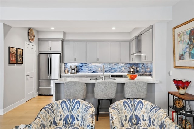 1920 S Pacific Coast Hwy, Redondo Beach, CA 90277 - kitchen with freestanding refrigerator, wall chimney exhaust hood, light wood-style flooring, decorative backsplash, and recessed lighting