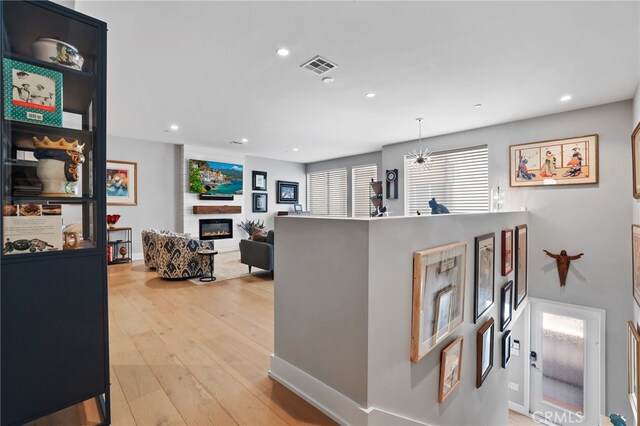 1920 S Pacific Coast Hwy, Redondo Beach, CA 90277 - kitchen with a large fireplace, recessed lighting, and light wood-style floors