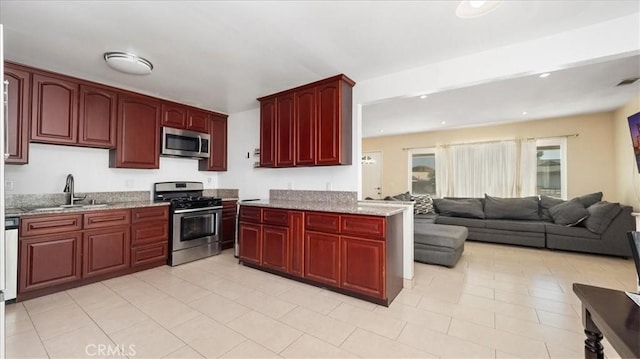 4440 Daniel Dr, Riverside, CA 92503 - kitchen featuring appliances with stainless steel finishes, dark brown cabinets, light stone counters, recessed lighting, and light tile patterned flooring