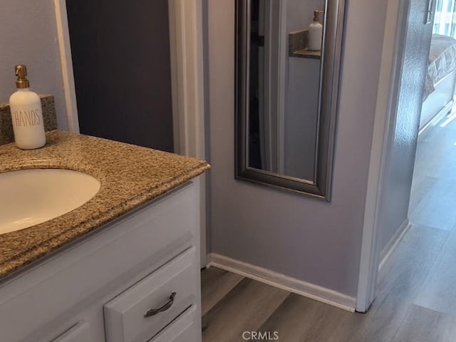 9647 Spyglass Ave Unit 18, Desert Hot Springs, CA 92240 - bathroom featuring wood finished floors and vanity
