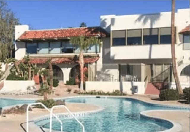 9647 Spyglass Ave Unit 18, Desert Hot Springs, CA 92240 - rear view of property featuring a balcony, a patio, and a community pool