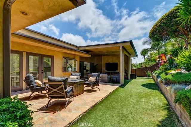 4557 Don Timoteo Dr, Los Angeles, CA 90008 - back of property featuring an outdoor living space, a fenced backyard, a patio area, stucco siding, and french doors