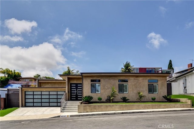 4557 Don Timoteo Dr, Los Angeles, CA 90008 - view of front of house with stucco siding and an attached garage
