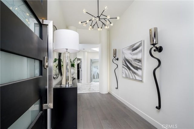 4557 Don Timoteo Dr, Los Angeles, CA 90008 - hall with a chandelier, dark wood-style floors, and a towering ceiling
