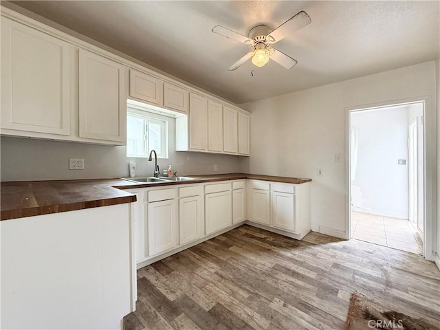 3864 Myers St, Riverside, CA 92503 - kitchen featuring light wood-type flooring, butcher block counters, a ceiling fan, and white cabinetry