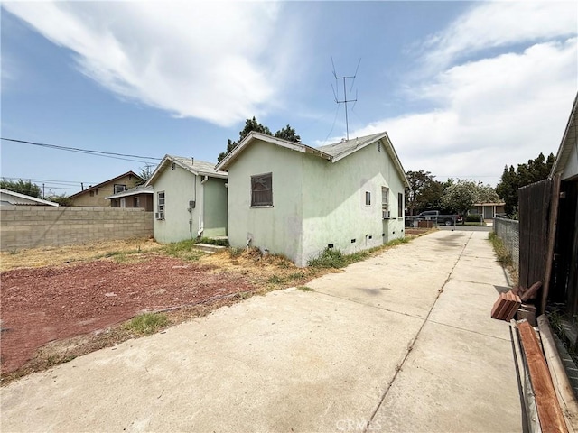 3864 Myers St, Riverside, CA 92503 - view of property exterior featuring driveway, stucco siding, and crawl space