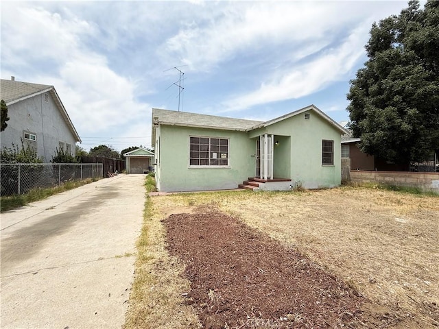 3864 Myers St, Riverside, CA 92503 - view of front of property featuring stucco siding, driveway, and a detached garage
