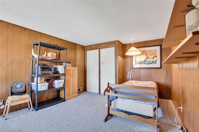 9452 El Valle Ave, Fountain Valley, CA 92708 - bedroom featuring wood walls, carpet, and a closet