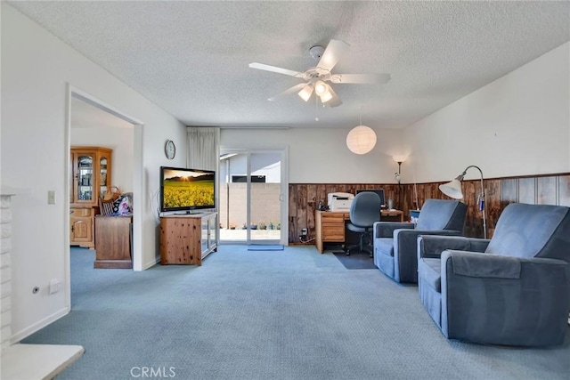 9452 El Valle Ave, Fountain Valley, CA 92708 - living room with carpet, a textured ceiling, and a ceiling fan