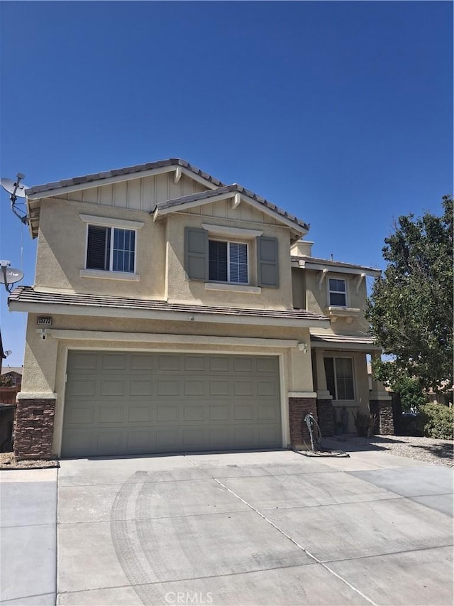 13772 Helena Ave, Victorville, CA 92392 - view of front of house featuring a garage, stucco siding, and driveway