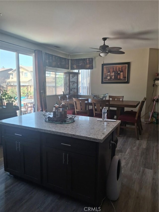 13772 Helena Ave, Victorville, CA 92392 - kitchen featuring dark wood-style flooring, dark cabinetry, a ceiling fan, and a kitchen island