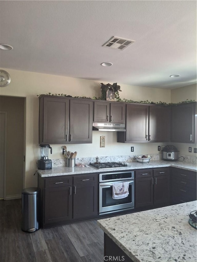 13772 Helena Ave, Victorville, CA 92392 - kitchen with stainless steel appliances, under cabinet range hood, dark wood-style floors, and light stone countertops