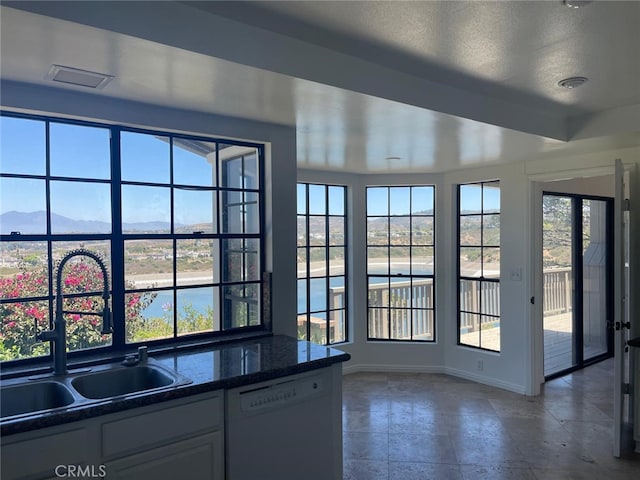 24 Coventry, Newport Beach, CA 92660 - kitchen featuring white dishwasher, healthy amount of natural light, a mountain view, and a textured ceiling