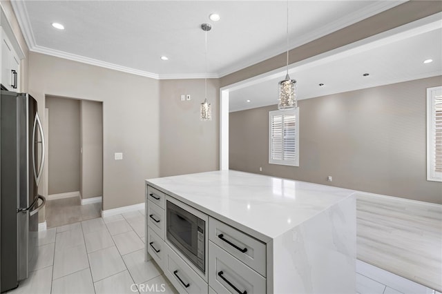 9 Cranwell, Aliso Viejo, CA 92656 - kitchen featuring appliances with stainless steel finishes, white cabinetry, decorative light fixtures, a kitchen island, and light stone counters