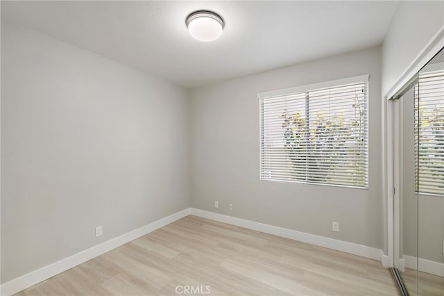 9 Cranwell, Aliso Viejo, CA 92656 - unfurnished bedroom featuring light wood-style floors, multiple windows, and a closet