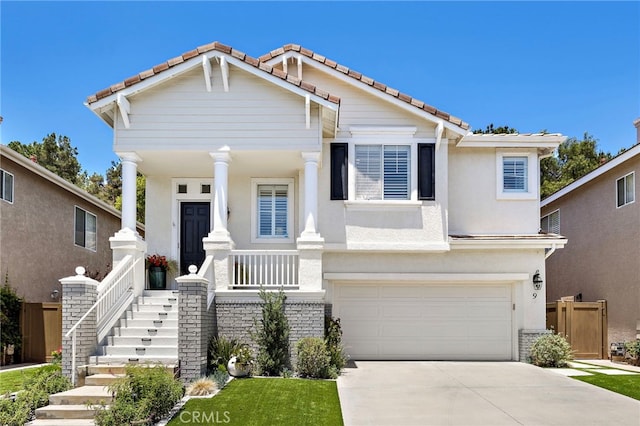 9 Cranwell, Aliso Viejo, CA 92656 - view of front of house featuring a porch, an attached garage, a tile roof, driveway, and stucco siding