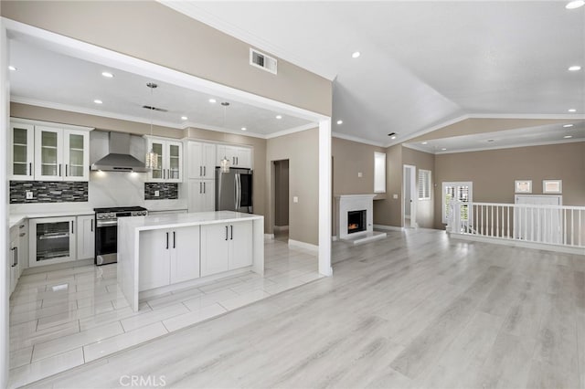 9 Cranwell, Aliso Viejo, CA 92656 - kitchen with stainless steel appliances, wall chimney range hood, beverage cooler, open floor plan, and a kitchen island