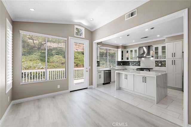 9 Cranwell, Aliso Viejo, CA 92656 - kitchen featuring wall chimney exhaust hood, stainless steel dishwasher, light countertops, tasteful backsplash, and glass insert cabinets