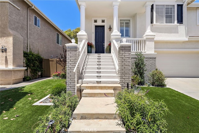 9 Cranwell, Aliso Viejo, CA 92656 - property entrance with stucco siding, an attached garage, concrete driveway, and a lawn
