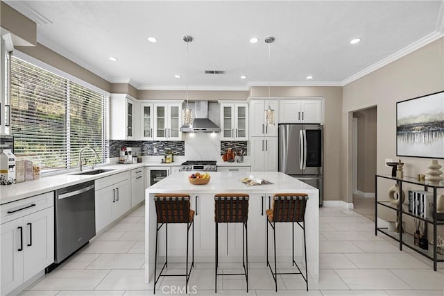 9 Cranwell, Aliso Viejo, CA 92656 - kitchen with wall chimney exhaust hood, appliances with stainless steel finishes, a kitchen bar, backsplash, and recessed lighting