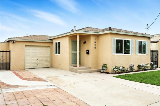 1446 Ravenna Ave, Wilmington, CA 90744 - view of front of home featuring stucco siding, concrete driveway, and an attached garage