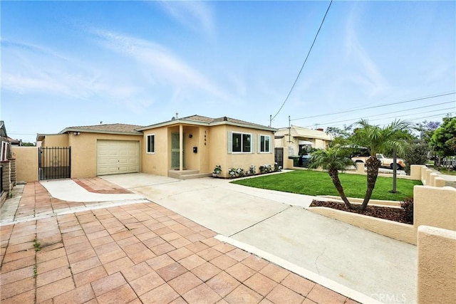 1446 Ravenna Ave, Wilmington, CA 90744 - view of front facade with stucco siding, concrete driveway, an attached garage, and a gate