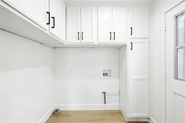1446 Ravenna Ave, Wilmington, CA 90744 - washroom featuring cabinet space, washer hookup, and light wood-style floors