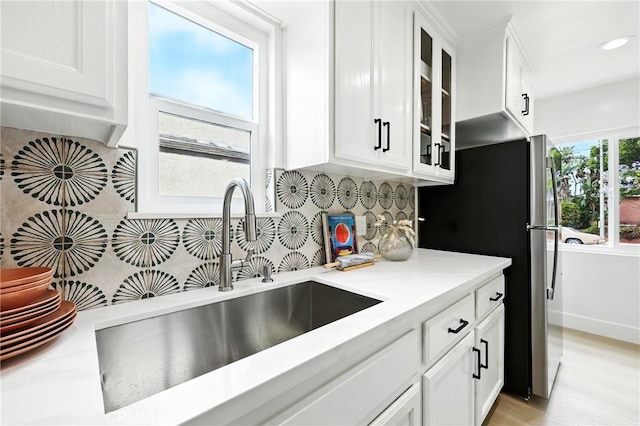 1446 Ravenna Ave, Wilmington, CA 90744 - kitchen featuring white cabinets, backsplash, glass insert cabinets, and recessed lighting