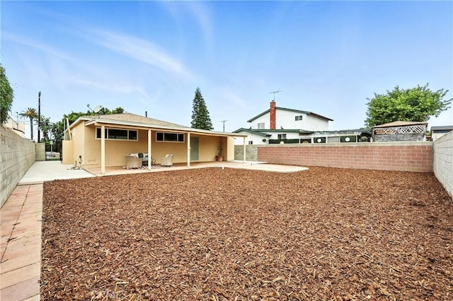 1446 Ravenna Ave, Wilmington, CA 90744 - rear view of house with a patio area, a fenced backyard, and stucco siding