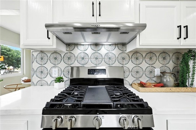 1446 Ravenna Ave, Wilmington, CA 90744 - kitchen featuring stainless steel gas stove, under cabinet range hood, tasteful backsplash, light countertops, and white cabinets