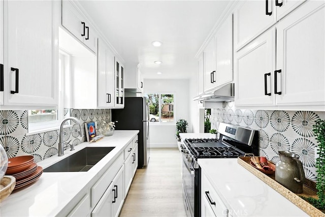 1446 Ravenna Ave, Wilmington, CA 90744 - kitchen with appliances with stainless steel finishes, under cabinet range hood, light wood finished floors, white cabinetry, and recessed lighting