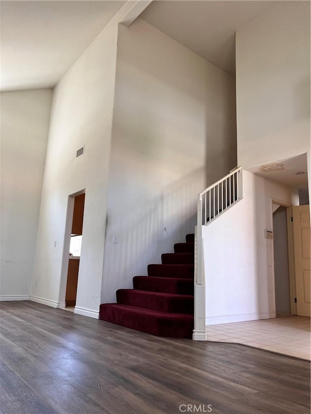 28499 Forest Oaks Way, Moreno Valley, CA 92555 - staircase featuring wood finished floors and a high ceiling